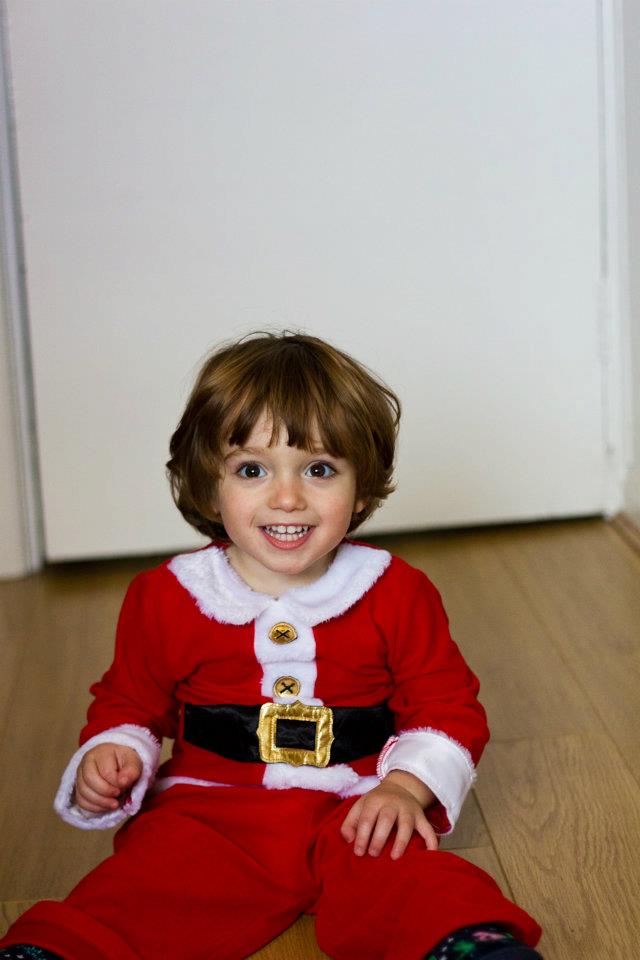 Toddler dressed as Santa