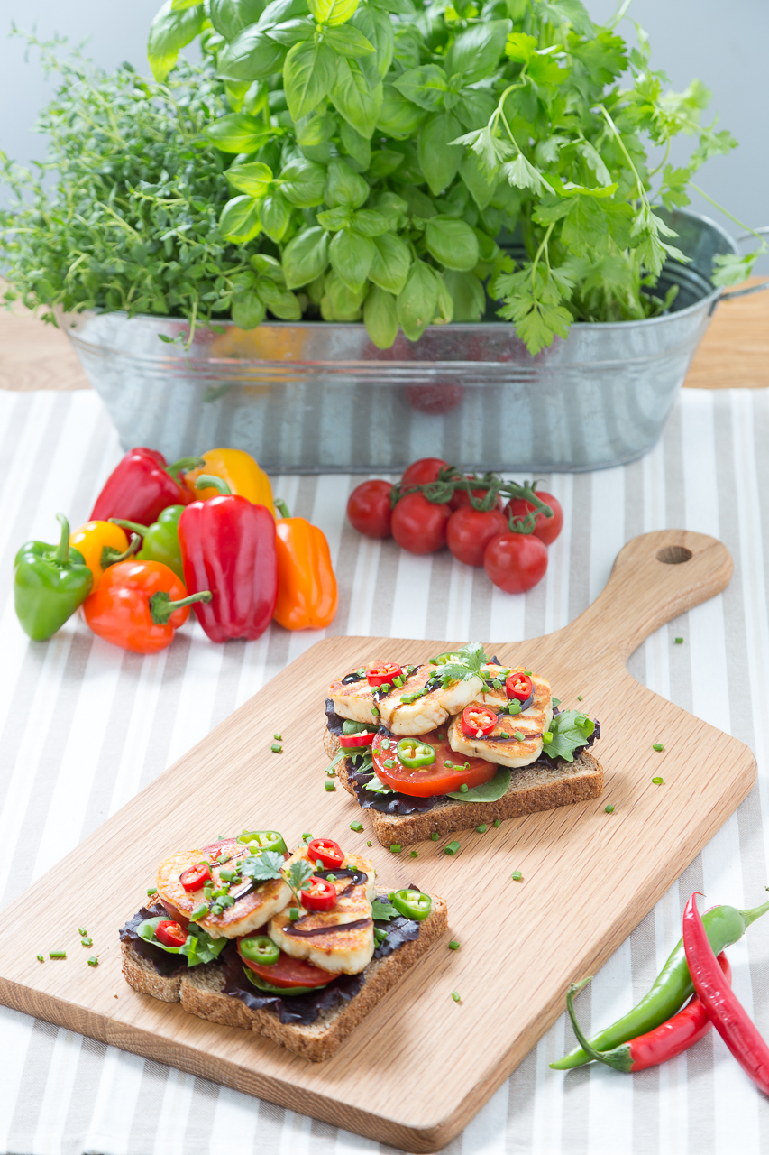 hallumi cheese open sandwiches with fresh herbs, peppers and tomatoes