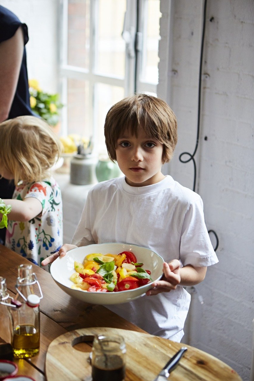 kids makes a tomato and basil salad as part of a cookery workshop with Jamie Oliver