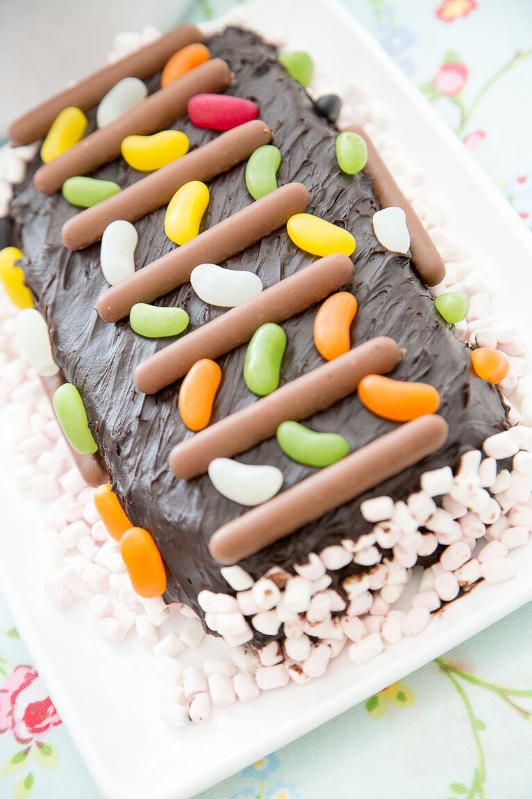 Pretty chocolate cake decorated with jelly beans, chocolate fingers and marshmallows