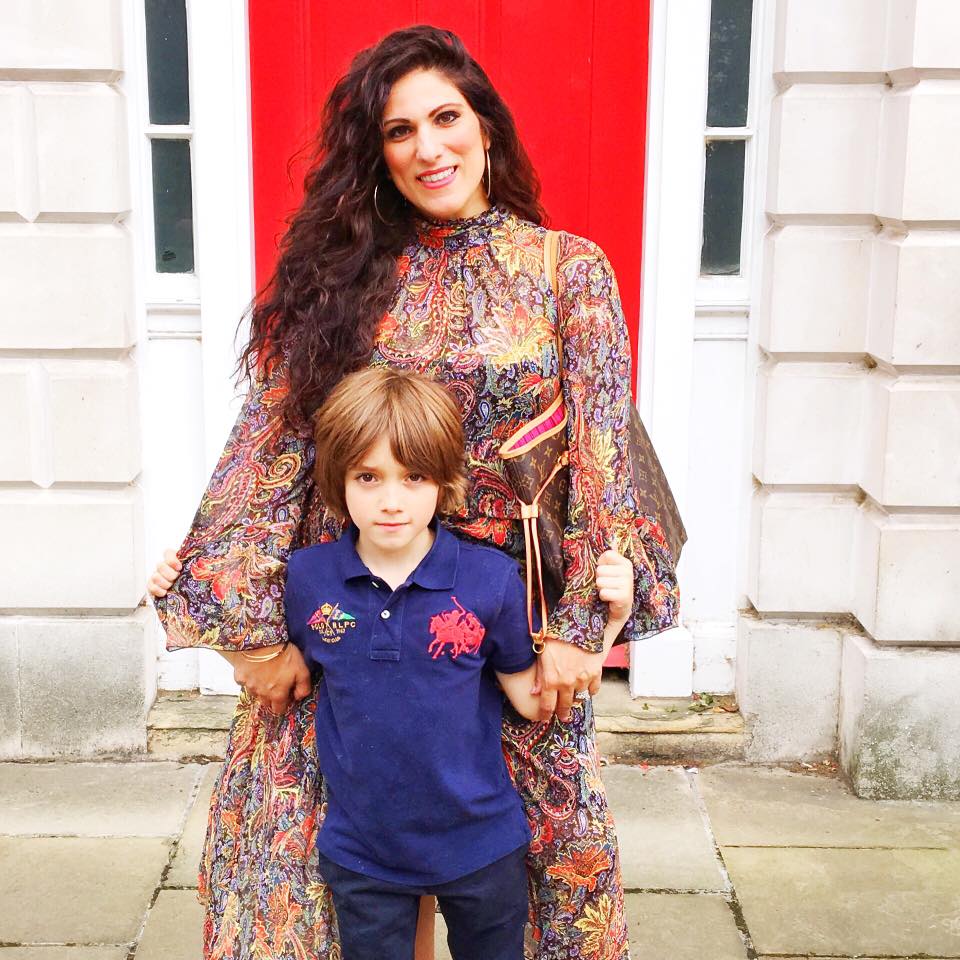 Honest Mum blogger posing in front of a red door with her son