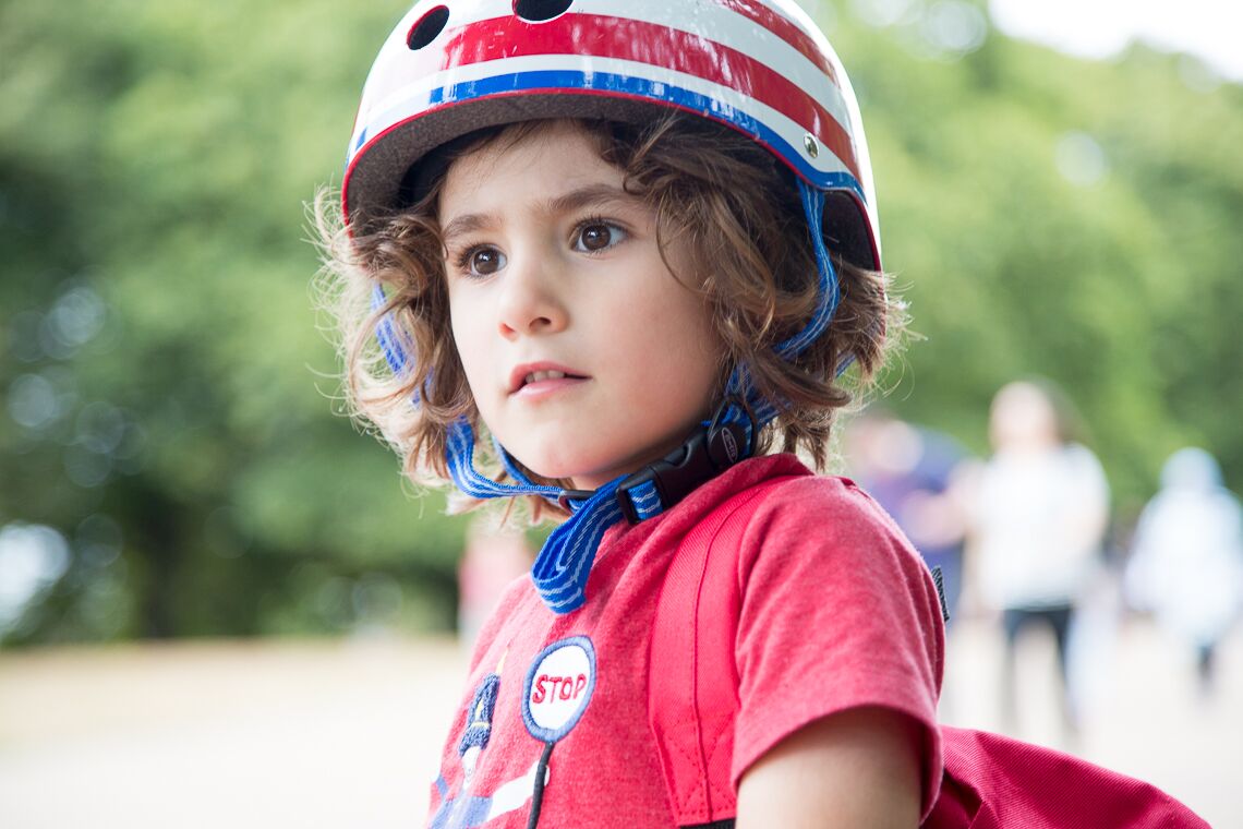 child on a scooter with his helmet on