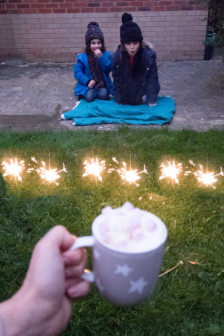 sparklers in the garden as kids watch in awe