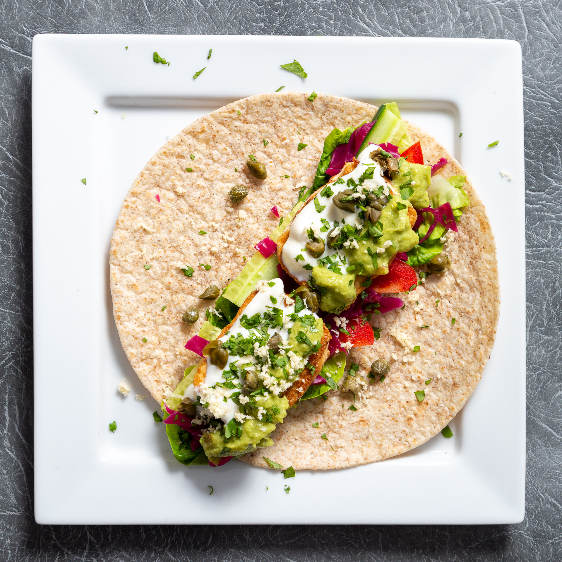 vegan wrap with tofu, guacamole and capers