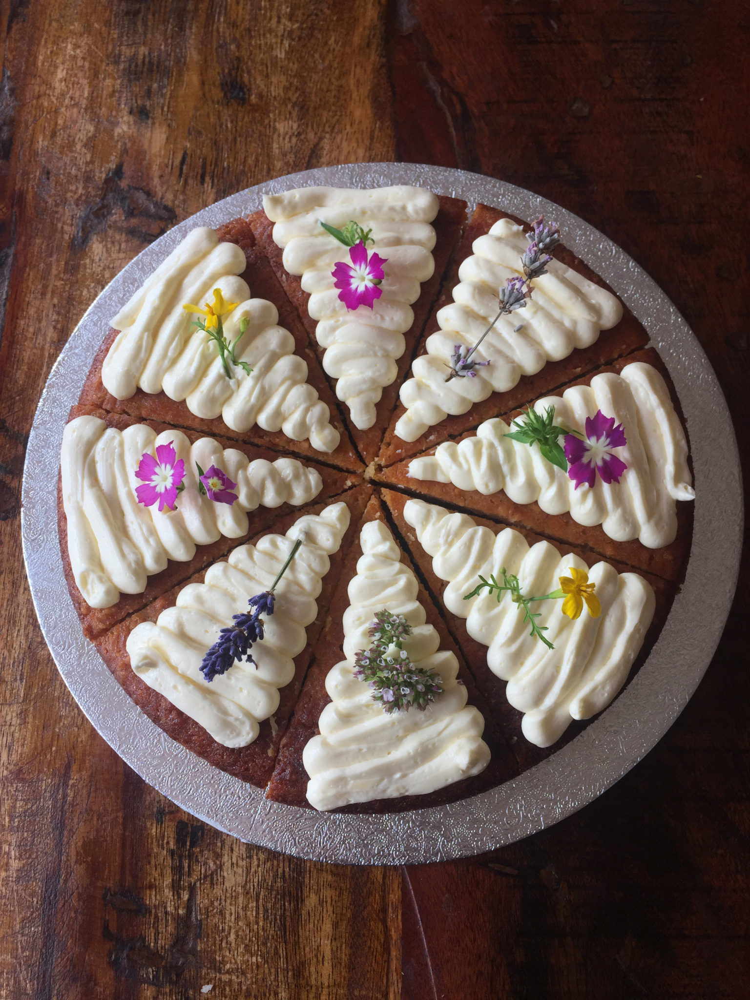 carrot cake...slice version, finished with edible organi flowers and buttercream swirls. perfect for pic nics and summer week ends