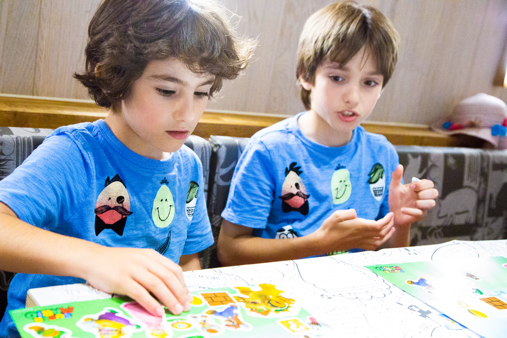 children playing with sticker sheets