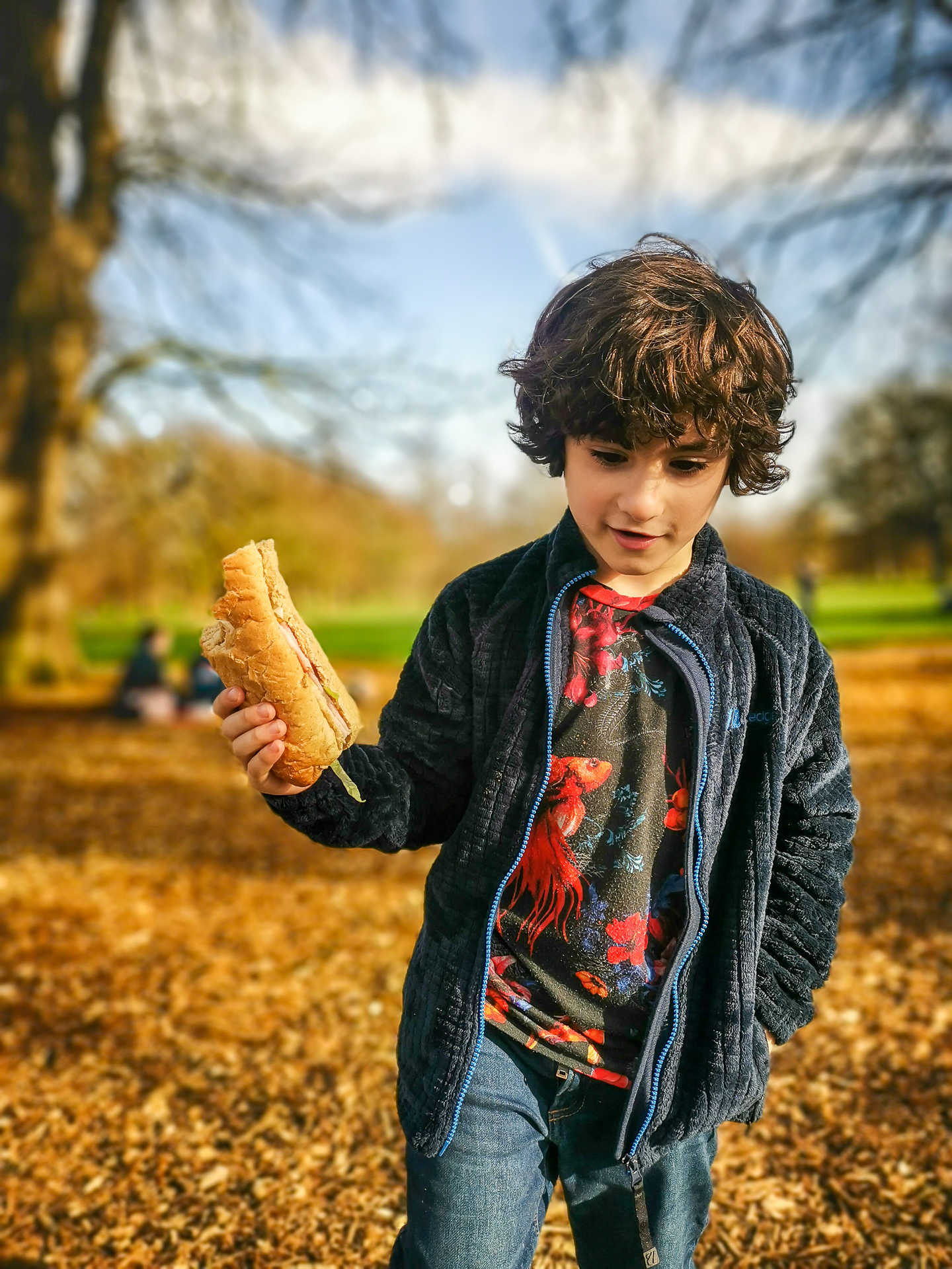 child eats a sandwich in Hyde Park