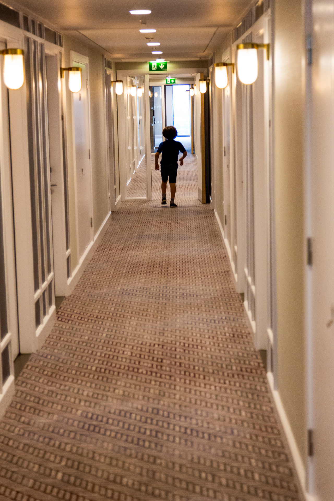 child walks through the corridor at The Laureate, Crown Plaza, Manchester
