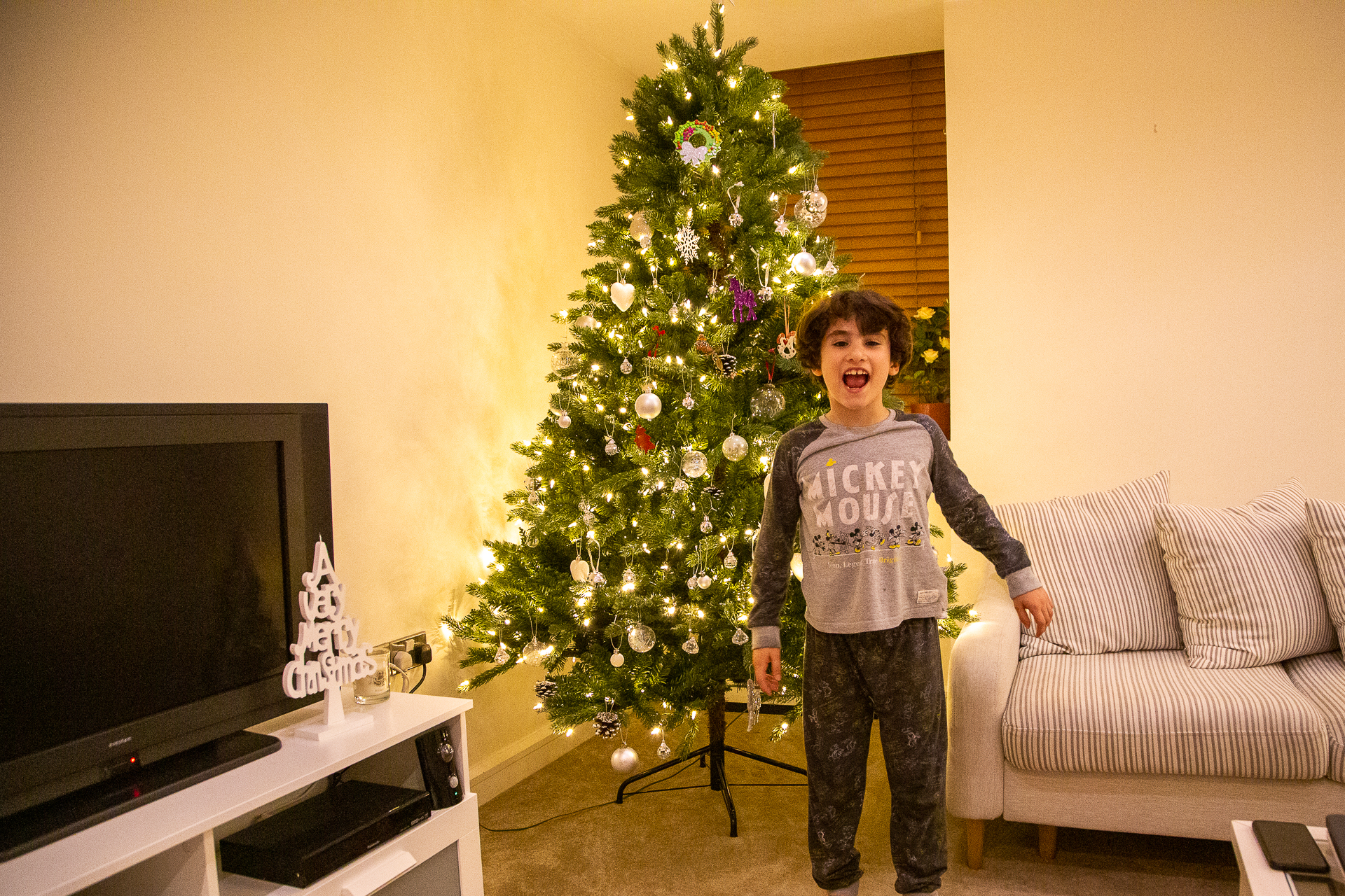kid in front of the Christmas tree